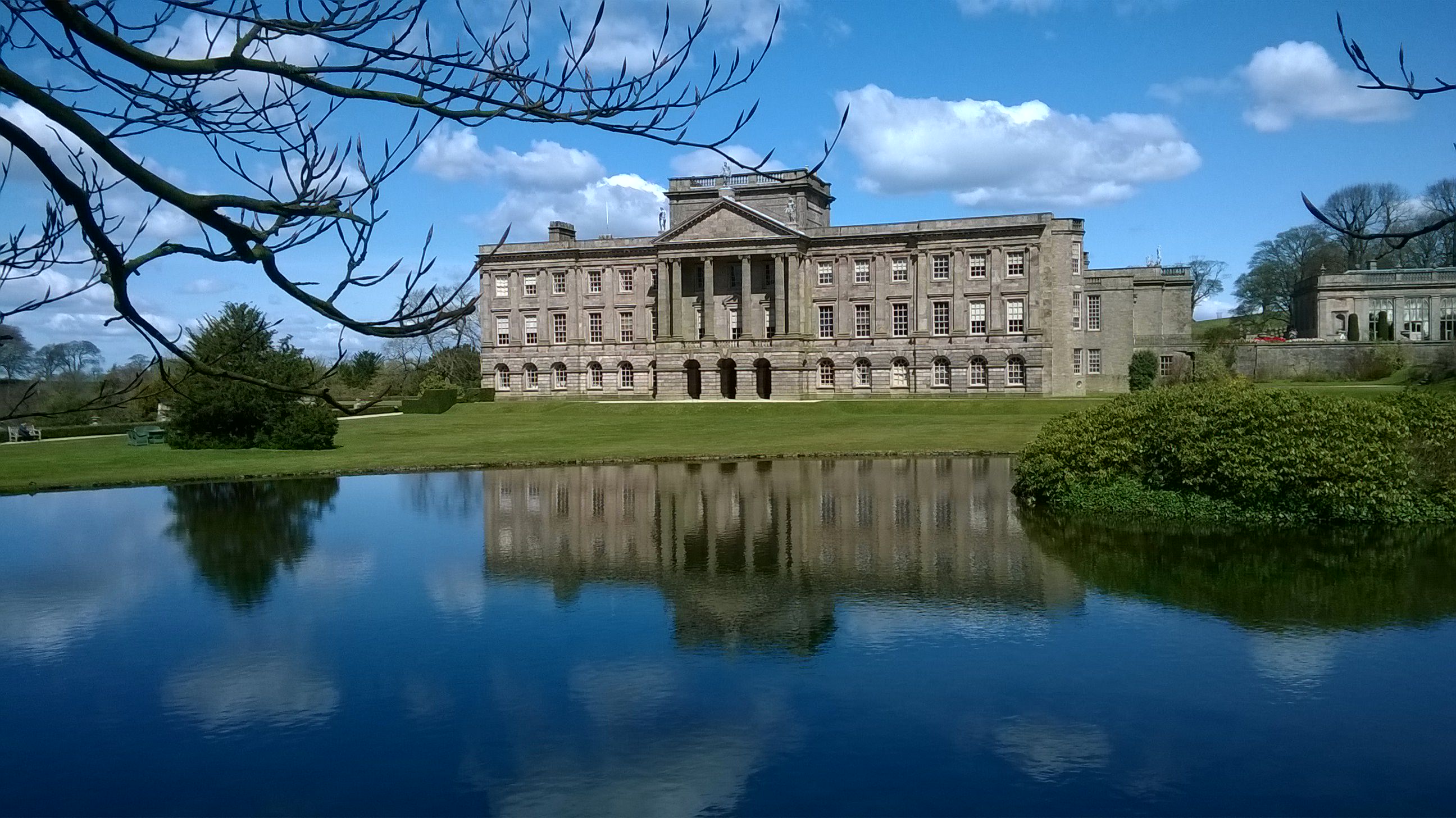 Photo of Lyme Hall from over the reflection lake